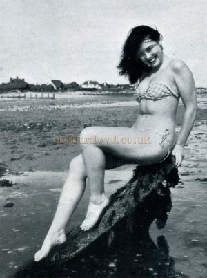 Outdoor shots for publicity purposes sometimes figure in Bandy's programme. Here is siren Doreen Loro on the conventional rock.