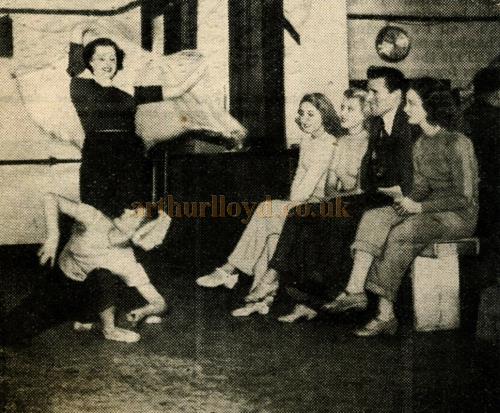 Caption Reads: Beryl Catlin (with cape) rehearses with Marion Lynde while (seated left to right) Madeleine Hearne, Ronnie Hudson, Cyril Roger and Maureen O'Dea look on. Cyril was beginning to overcome his stage-fright.