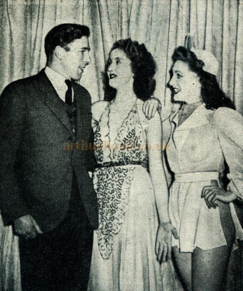 While the tired businessmen waited in the orchestra stalls, lucky Cyril chatted with charming Joy Marlowe (centre) and Carole Jeffries in the wings before they made their entrance.