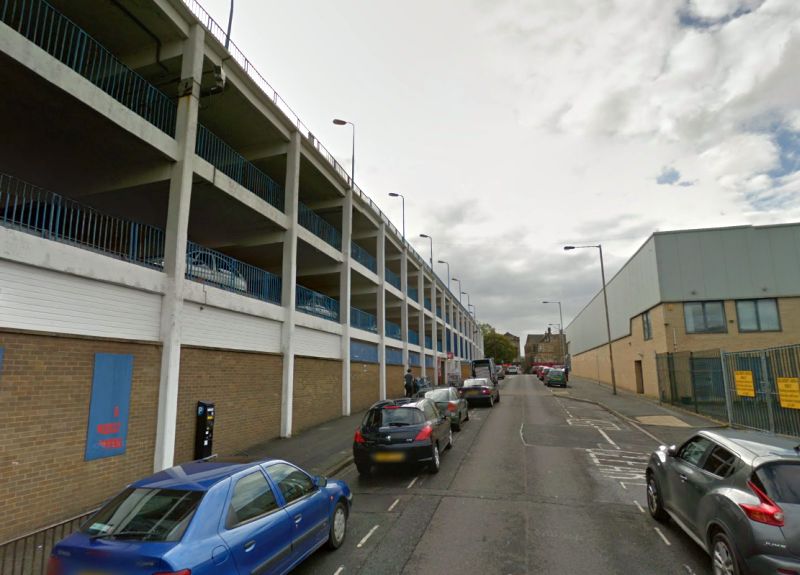 A Google StreetView Image of Rawson Street, Bradford, formerly Brunswick Place. Between 1869 and 1889 Pullan's Music Hall was situated where the carpark is today - Click to Interact.